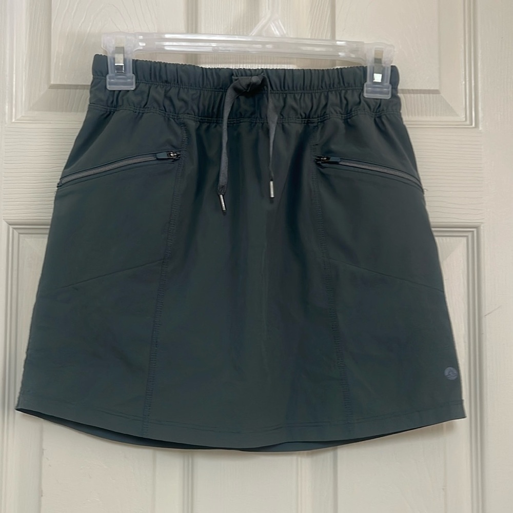 Apana army green skort size XS. signs of wear on both sides of the skort.